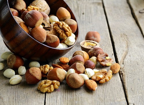 Mix nuts (almonds, hazelnuts, walnuts) on a wooden table